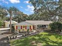 Charming ranch home with lush landscaping, and a spacious yard at 1281 Gray Ct, Eustis, FL 32726