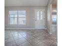 Living room with tiled floors, large window and interior door at 1320 Arredondo Dr, The Villages, FL 32162