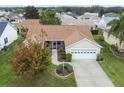 Single-story home with a large yard, driveway, and attached garage at 17848 Se 87Th Bourne Ave, The Villages, FL 32162