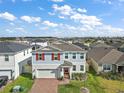 Two-story house with red shutters and a view of the surrounding neighborhood at 2226 Satin Leaf St, Clermont, FL 34711