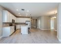 Modern kitchen featuring white cabinets, stainless steel appliances, and an island at 2878 Supermarine Rd, Tavares, FL 32778