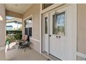 Front porch with seating and a decorative door at 3640 Mount Hope Loop, Leesburg, FL 34748