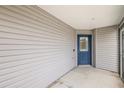 Side entrance with blue door and light beige vinyl siding at 4056 Venetian Ln, The Villages, FL 32163