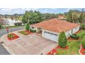 Single-story home with a two-car garage and landscaped yard at 5312 Galley Way, Oxford, FL 34484