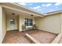 Brick paved porch with seating and a view of the front yard at 5312 Galley Way, Oxford, FL 34484