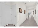 Bright and airy hallway with tile flooring and access to other rooms at 8128 Penrose Pl, Wildwood, FL 34785