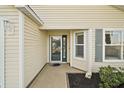 Front entry with a glass door and decorative landscaping at 3810 Cosmos Way, The Villages, FL 32163