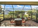 Screened patio with brick flooring and outdoor furniture at 3810 Cosmos Way, The Villages, FL 32163