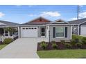 Two-car garage and gray siding with red accents at 5820 Bamboo Ave, The Villages, FL 32163