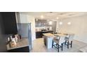 Modern kitchen with island, stainless steel appliances, and granite countertops at 716 Se 64Th Ter, Ocala, FL 34472