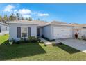 Gray house with two car garage and well maintained lawn at 1109 Catskill Dr, Haines City, FL 33844