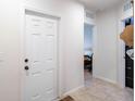 White door and view into bedroom with tile floor at 1109 Catskill Dr, Haines City, FL 33844
