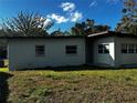 Another side view of the house with a grassy yard at 1400 Palm Dr, Mount Dora, FL 32757