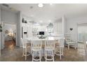 White kitchen with an island, stainless steel appliances and quartz countertops at 17640 Se 81St Timberwood Ter, The Villages, FL 32162