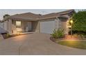 Well-lit single-story home with a two-car garage and landscaped yard at 2243 Montbrook Pl, The Villages, FL 32162