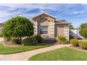 Single-story house with a landscaped yard and walkway at 2243 Montbrook Pl, The Villages, FL 32162