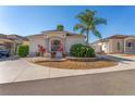 Single-story house with palm trees and a manicured lawn at 2382 Othello Ct, The Villages, FL 32162