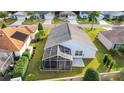 Aerial view showcasing a home with a screened-in patio at 2485 Ansley Path, The Villages, FL 32162