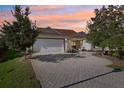 Inviting home exterior with a paved driveway and landscaping at 2876 Manor Downs, The Villages, FL 32162