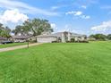 House with a large front yard and driveway at 5126 County Road 125, Wildwood, FL 34785