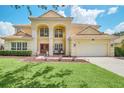 Two-story house with a large front yard, double doors, and a three-car garage at 6607 Crestmont Glen, Windermere, FL 34786