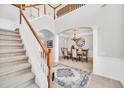 Elegant two-story entryway with a grand staircase, chandelier, and formal dining area at 6607 Crestmont Glen, Windermere, FL 34786