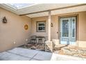 Quaint front porch with tile flooring and seating area at 3219 Landing Vw, Tavares, FL 32778