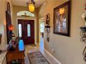 Bright and spacious entryway with a decorative console table and mirror at 752 Maybank Loop, The Villages, FL 32162