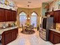 Kitchen boasts ample cabinetry, stainless steel appliances, and a breakfast nook at 752 Maybank Loop, The Villages, FL 32162