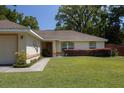 Front view of house showcasing the entrance and landscaping at 5 Hemlock Terrace Pass, Ocala, FL 34472