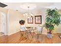 Bright dining room with a glass-top table and hardwood floors at 8033 Sw 81St Loop, Ocala, FL 34476