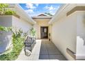 Inviting entryway with a bench and lush greenery at 8033 Sw 81St Loop, Ocala, FL 34476