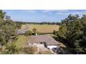 Aerial view of a ranch-style home on a large lot with a paved driveway at 1801 Ne 77Th St, Ocala, FL 34479