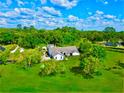 Aerial view of a house on a large lot with mature trees at 7205 Ne 61St Avenue Rd, Silver Springs, FL 34488
