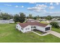 Single story home with red roof, large yard, and screened porch at 11050 Sw 62Nd Ct, Ocala, FL 34476