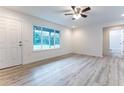 Bright living room with wood-look floors and a view of the backyard at 781 Ne 130Th Ter, Silver Springs, FL 34488