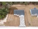 Aerial view of a house with geometric driveway and landscaping at 13050 Ne 7Th Loop, Silver Springs, FL 34488