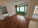 Bright dining area with wood flooring and a bay window at 9981 Sw 59Th Cir, Ocala, FL 34476