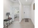 Bright and airy entryway with tile flooring and views to the living room at 348 Hickory Course Radl, Ocala, FL 34472