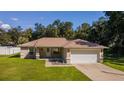House with a spacious yard, driveway, and a peaceful neighborhood at 13589 Se 100Th Ave, Belleview, FL 34420