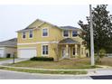 Two-story house with a two-car garage and neatly landscaped yard at 369 James Cir, Lake Alfred, FL 33850