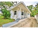 Charming mid-century home with a covered porch and well-maintained landscaping at 103 13Th Se St, Winter Haven, FL 33880