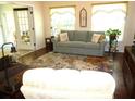 Living room with tile floors, couch and two armchairs at 948 Old Cutler Rd, Lake Wales, FL 33898