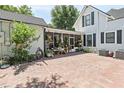 Brick paved patio with screened porch and abundant potted plants at 350 E Park Ave, Lake Wales, FL 33853