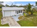 White single story home with carport and palm trees at 404 Thomas Ave, Frostproof, FL 33843