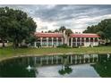 Building exterior on a canal with palm trees and lush landscaping at 8203 Village Dr # 8203, Lake Wales, FL 33898