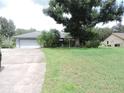 Single-story home with attached garage and large yard at 3547 Red Oak Court, Lake Wales, FL 33898