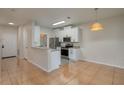 Modern kitchen with white cabinets, stainless steel appliances, and a breakfast bar at 5011 Hemingway Cir # 5011, Haines City, FL 33844