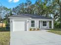 Newly built one-story house featuring a white garage door and concrete driveway at 815 S Seminole Ave, Fort Meade, FL 33841