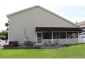 House exterior showcasing a covered patio and well-manicured lawn at 337 Motorcoach S Dr, Polk City, FL 33868